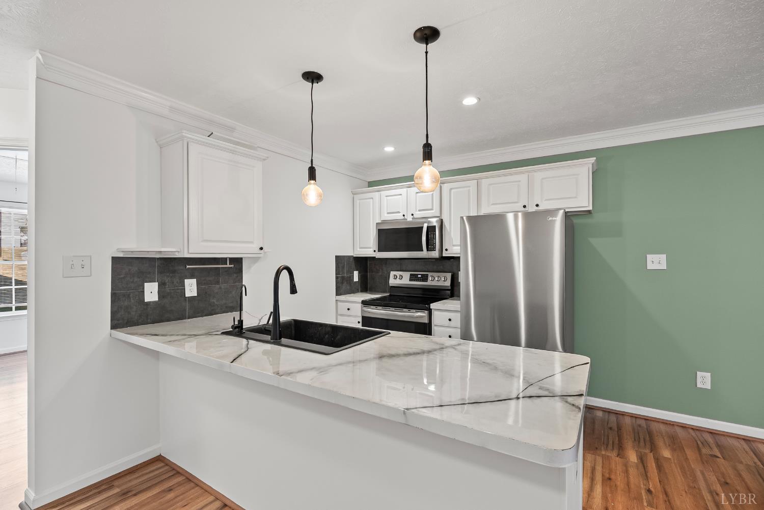 300 McConville Road, Unit 63 Lynchburg, VA 24502 - Photo 21 of 37 a kitchen with stainless steel appliances a refrigerator a stove a sink and a wooden floor