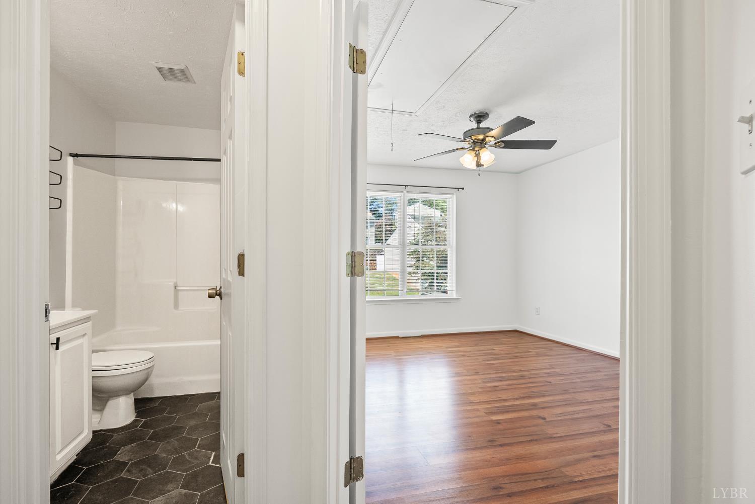 300 McConville Road, Unit 63 Lynchburg, VA 24502 - Photo 24 of 37 a view of a bathroom with a toilet sink a mirror and a shower