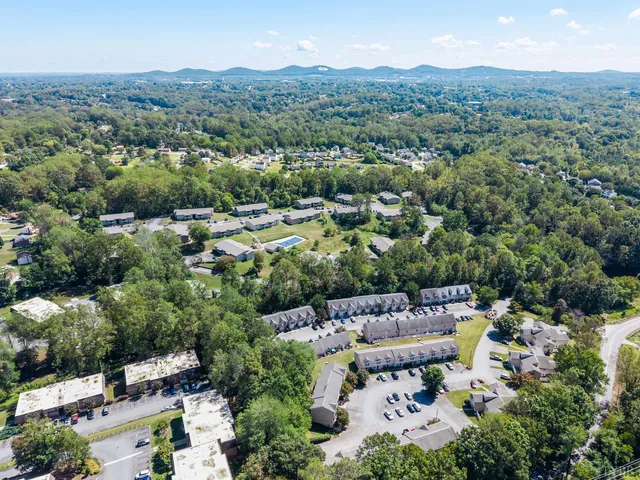 an aerial view of a house with a yard and garden