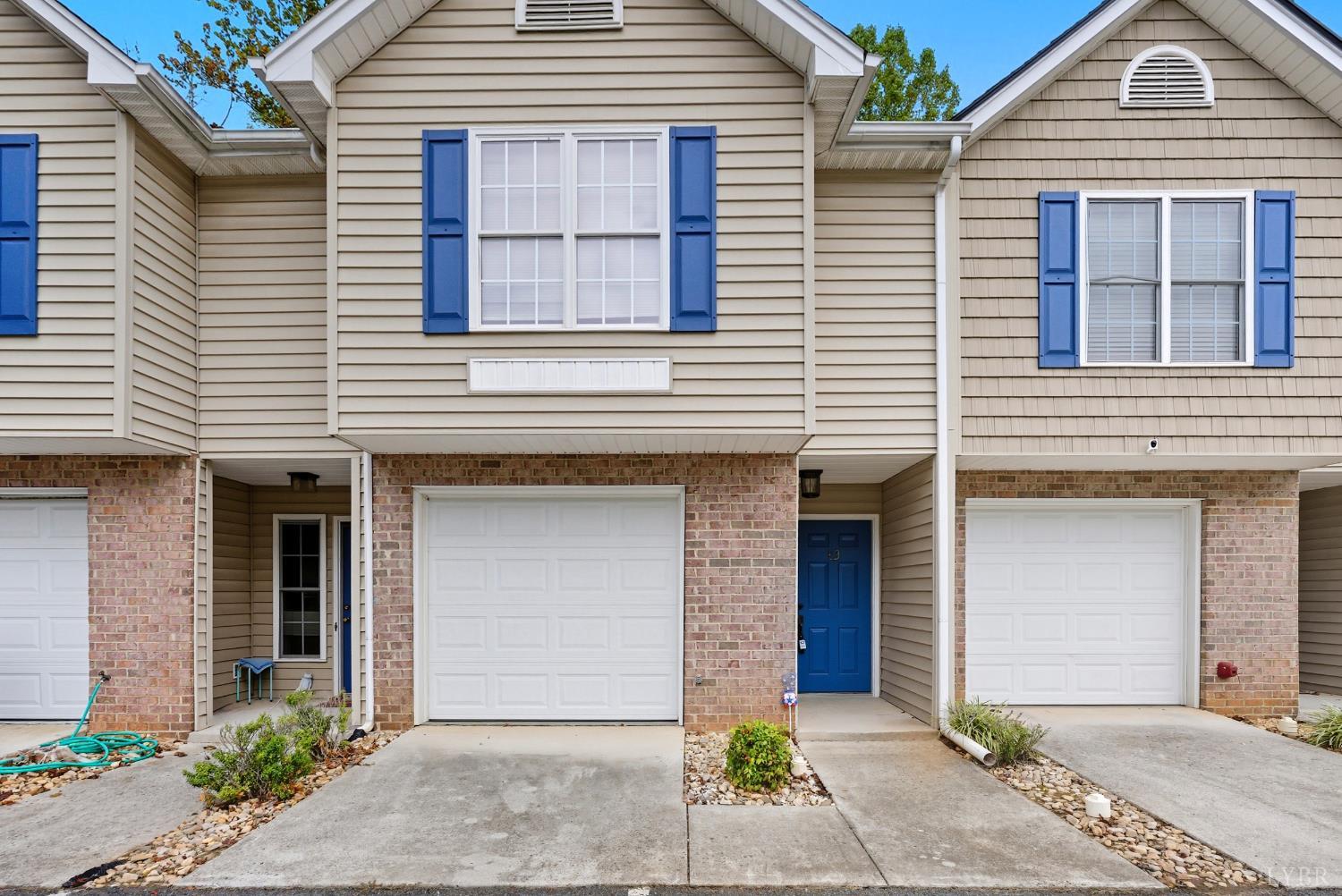300 McConville Road, Unit 63 Lynchburg, VA 24502 - Photo 4 of 37 a front view of a house with a yard and garage