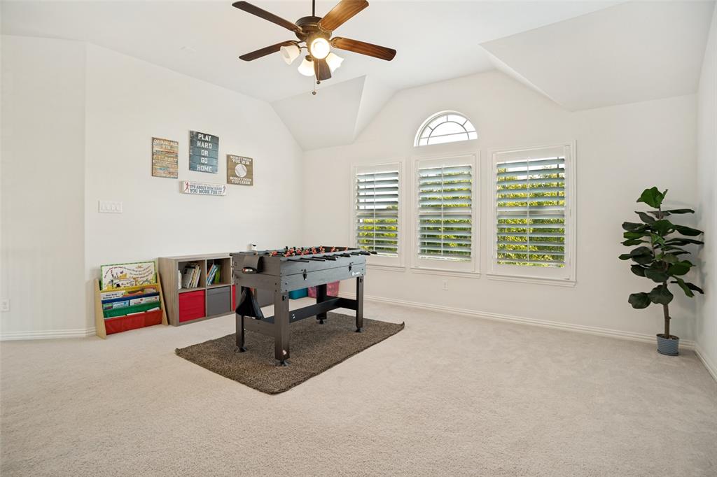 1461 Ramsbury Lane Prosper, TX 75078 - Photo 15 of 30 Spacious room featuring vaulted ceilings, light neutral carpeting, and a ceiling fan with integrated lighting