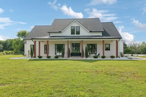 a front view of house with yard and outdoor seating