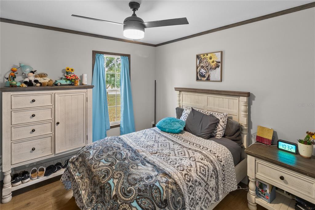 10850 Northeast 110th Lane Archer, FL 32618 - Photo 11 of 24 a bedroom with a bed and a chandelier