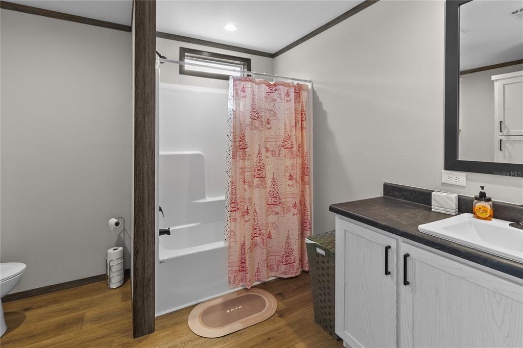 10850 Northeast 110th Lane Archer, FL 32618 - Photo 13 of 24 a bathroom with a granite countertop sink a mirror and shower