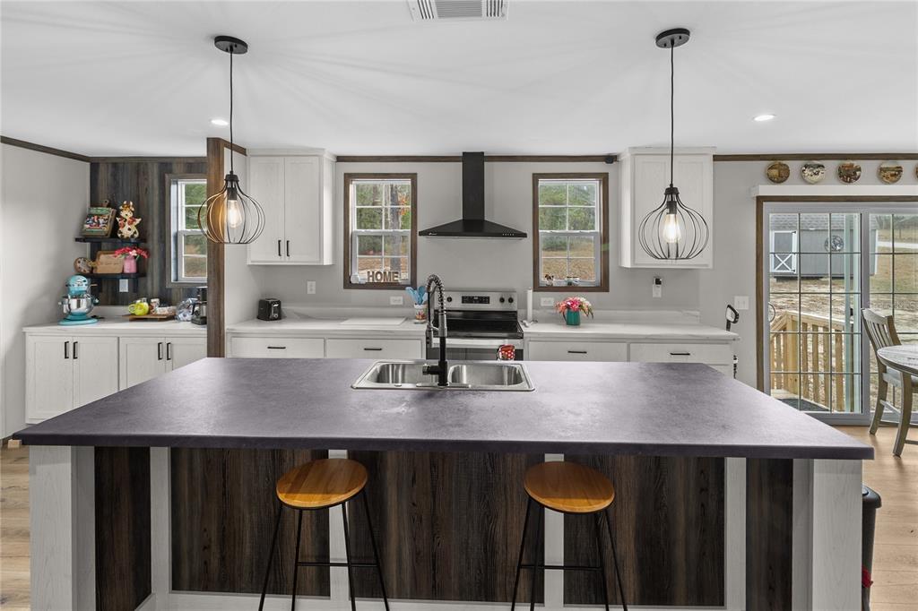 10850 Northeast 110th Lane Archer, FL 32618 - Photo 2 of 24 a kitchen with a table chairs and wooden floor