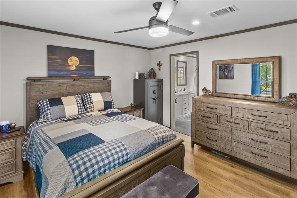 10850 Northeast 110th Lane Archer, FL 32618 - Photo 8 of 24 a bedroom with a large bed and a dresser