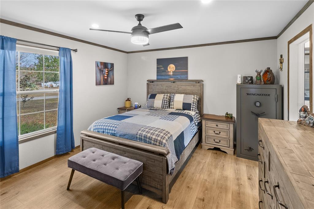 10850 Northeast 110th Lane Archer, FL 32618 - Photo 9 of 24 a bedroom with a bed a dresser next to a window