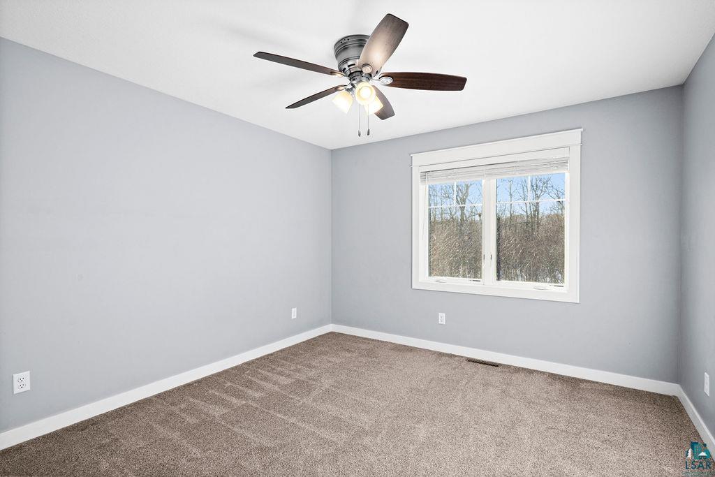 3879 Okerstrom Road Hermantown, MN 55811 - Photo 20 of 32 Empty room with light colored carpet and a ceiling fan