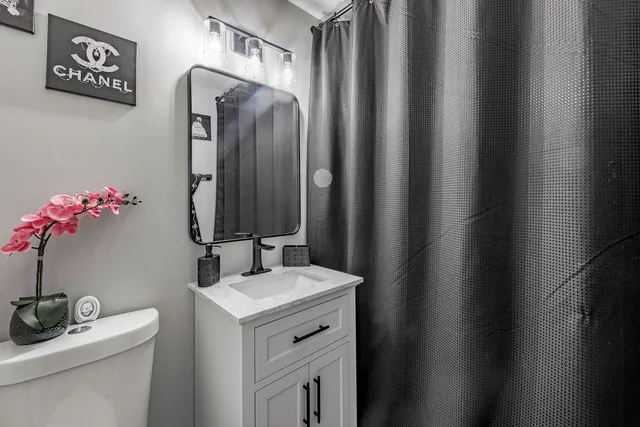 a bathroom with a sink vanity and a mirror