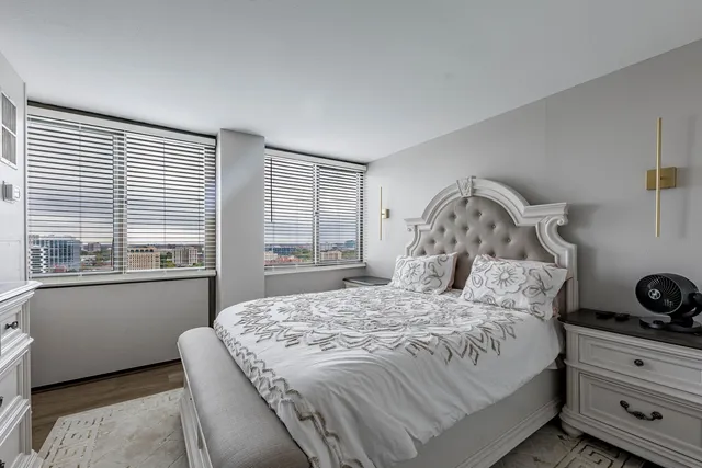 a bedroom with a bed and a window