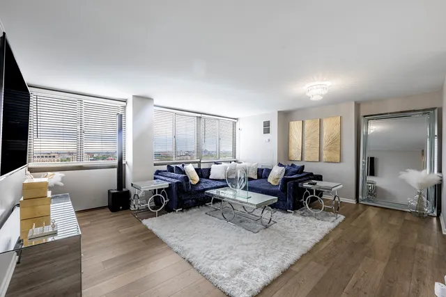 a living room with furniture window and wooden floor