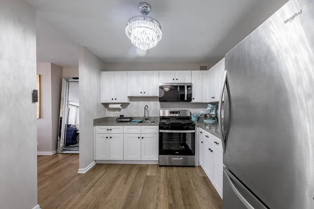 a kitchen with stainless steel appliances a refrigerator stove microwave and cabinets