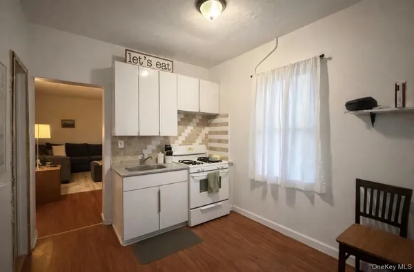 a kitchen with a stove a sink and a refrigerator