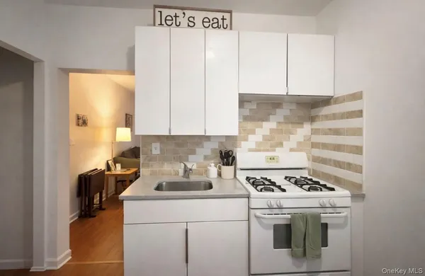 a kitchen with a stove and a white cabinet