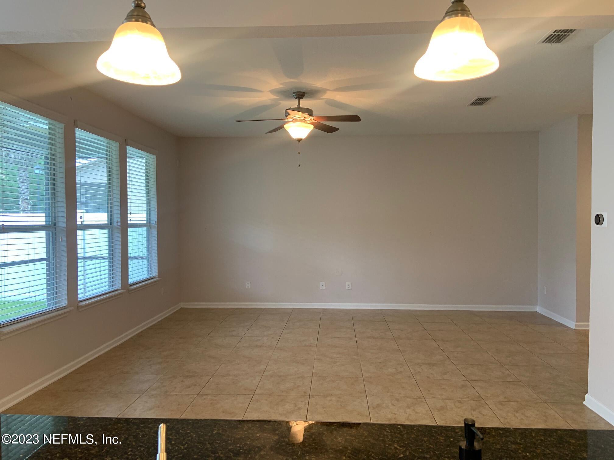 3863 Chasing Falls Road Orange Park, FL 32065 - Photo 11 of 32 wooden floor in an empty room with a window