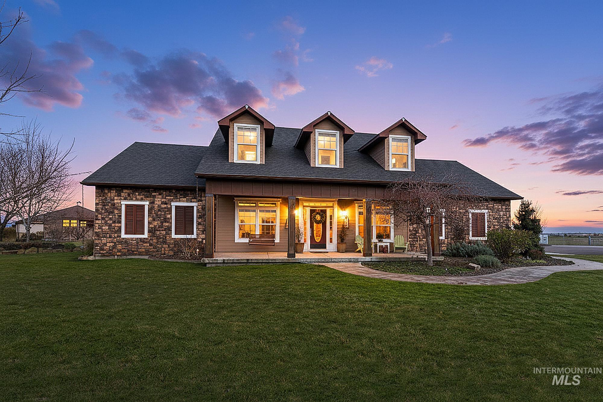 View of front yard and home featuring covered porch, swing and stone accents