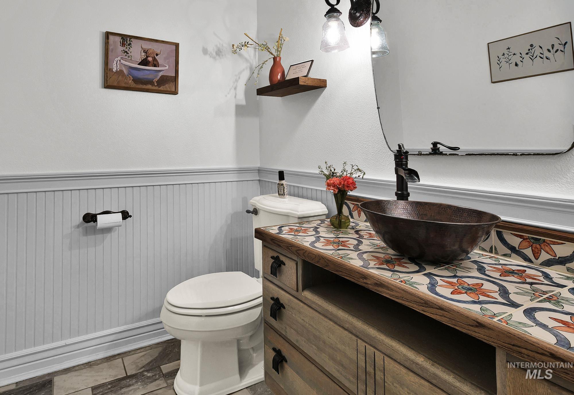 19288 Majestic View Place Caldwell, ID 83607 - Photo 22 of 50 Half bath with a wainscoted wall and vanity