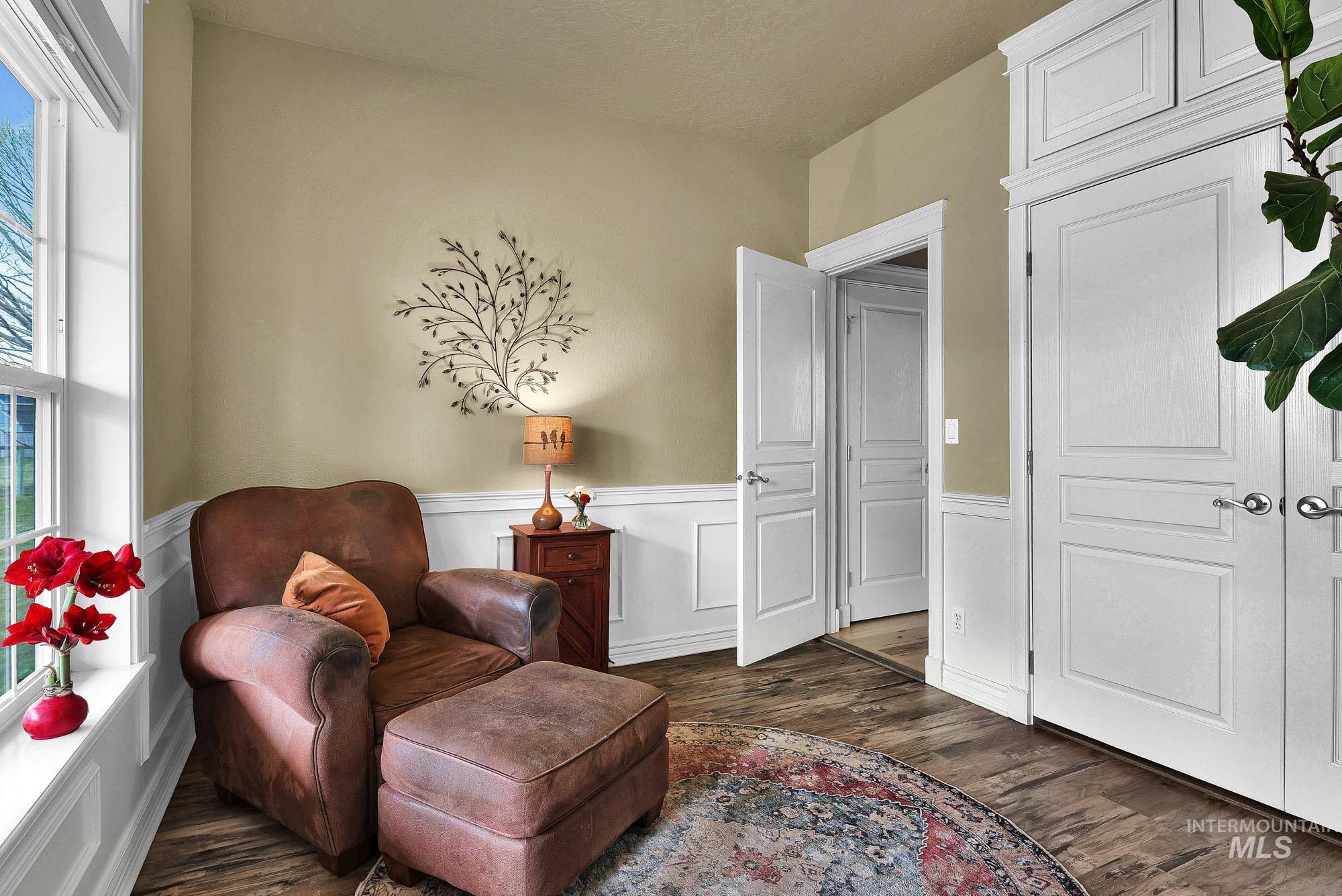 19288 Majestic View Place Caldwell, ID 83607 - Photo 23 of 50 Sitting room with dark wood-style floors and wainscoting