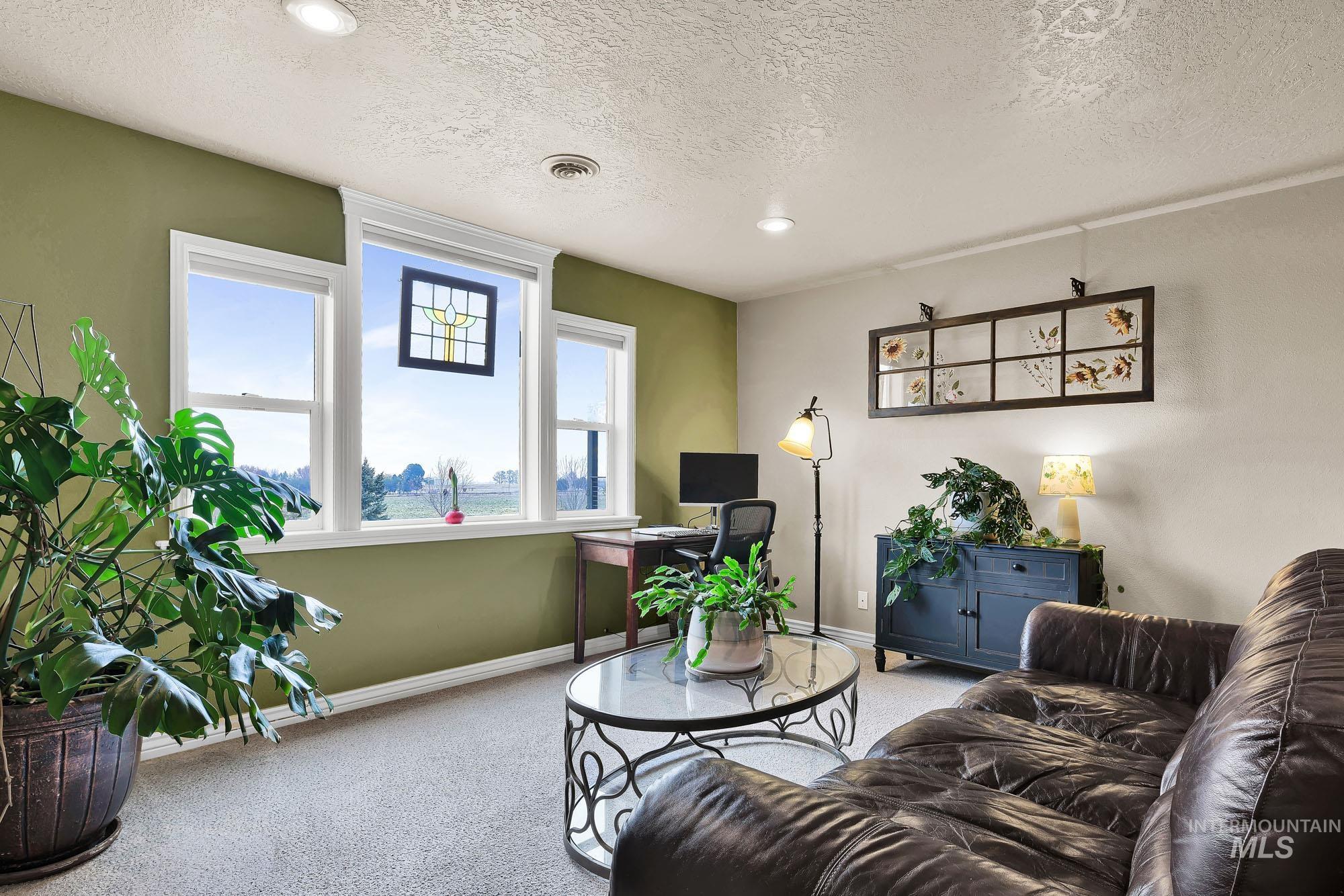 19288 Majestic View Place Caldwell, ID 83607 - Photo 27 of 50 Loft/ Bonus area with an office area, a large window view of the mountains, carpet flooring, and recessed lighting