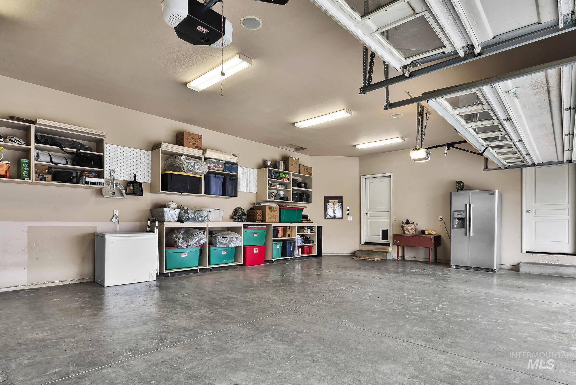 19288 Majestic View Place Caldwell, ID 83607 - Photo 35 of 50 3 car Garage with built in shelving, fully painted and insulated with a garage door opener