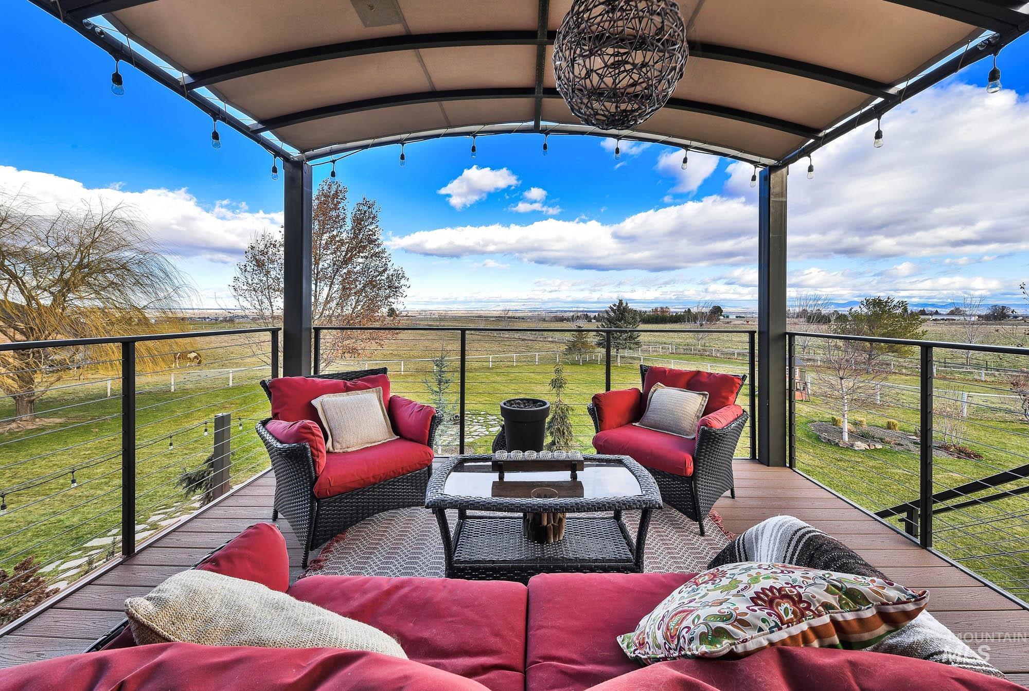 19288 Majestic View Place Caldwell, ID 83607 - Photo 41 of 50 Upper terrace featuring an outdoor gathering space, a view of the expansive lawn, and a view of the mountains and area