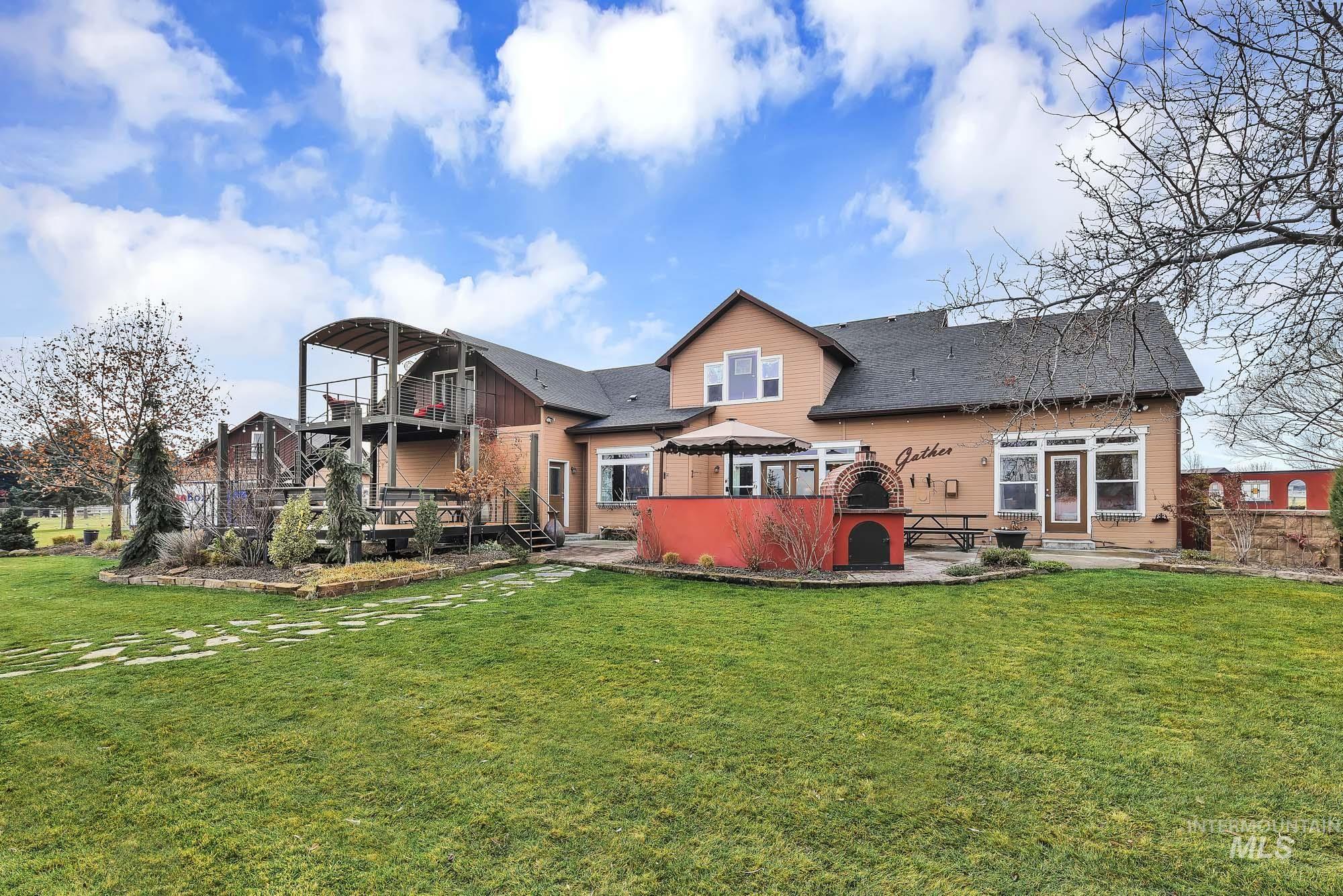 19288 Majestic View Place Caldwell, ID 83607 - Photo 42 of 50 Back of house featuring the expansive yard and a patio gathering area