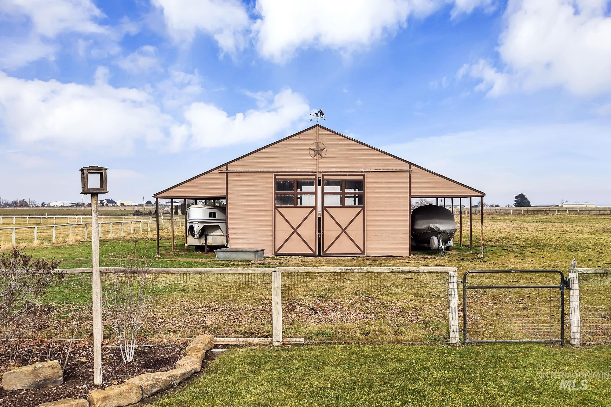 19288 Majestic View Place Caldwell, ID 83607 - Photo 46 of 50 View of pole barn with side coverings for RVs or farm equipment - a view of countryside and distant mountains
