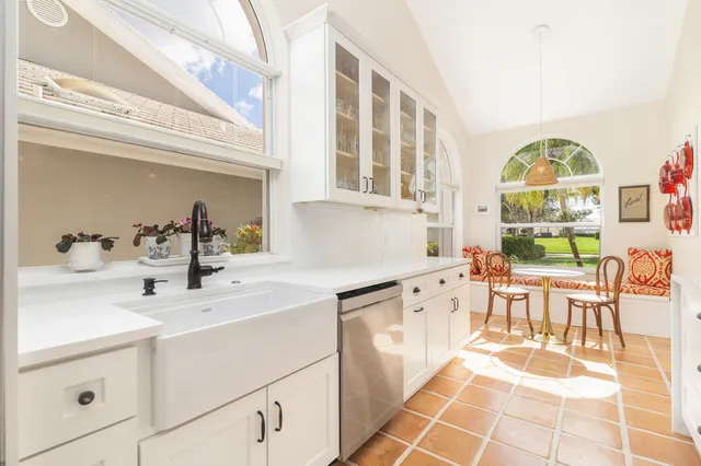 a dining room with furniture and a window