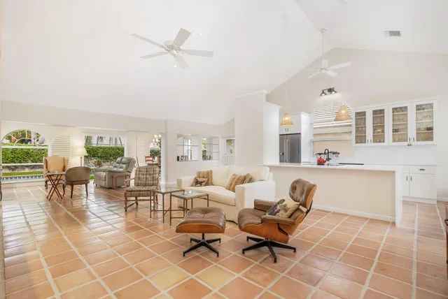 a living room with furniture and floor to ceiling windows