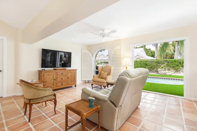 a living room with furniture a fireplace and a large window