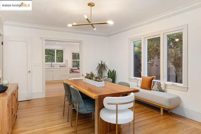 a view of a hallway with wooden floor and a bathroom