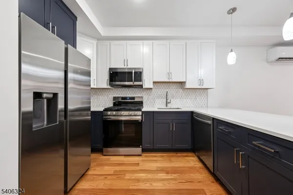 a kitchen with stainless steel appliances granite countertop a refrigerator stove and microwave