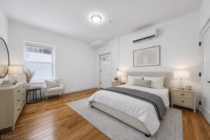 52 James Street, Unit 1 Newark, NJ 07102 - Photo 13 of 28 a bedroom with a bed and a couch