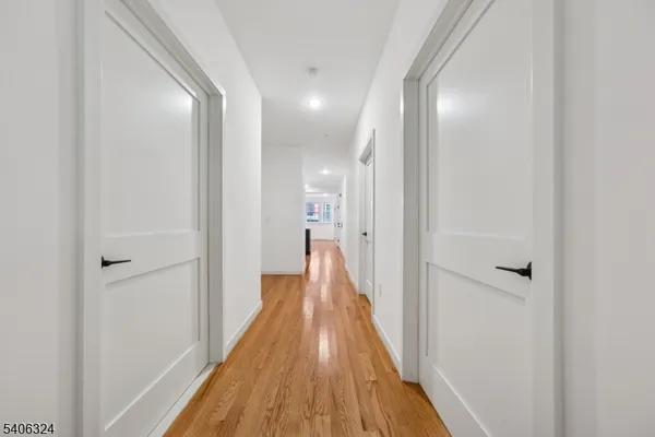 a view of a hallway with wooden floor