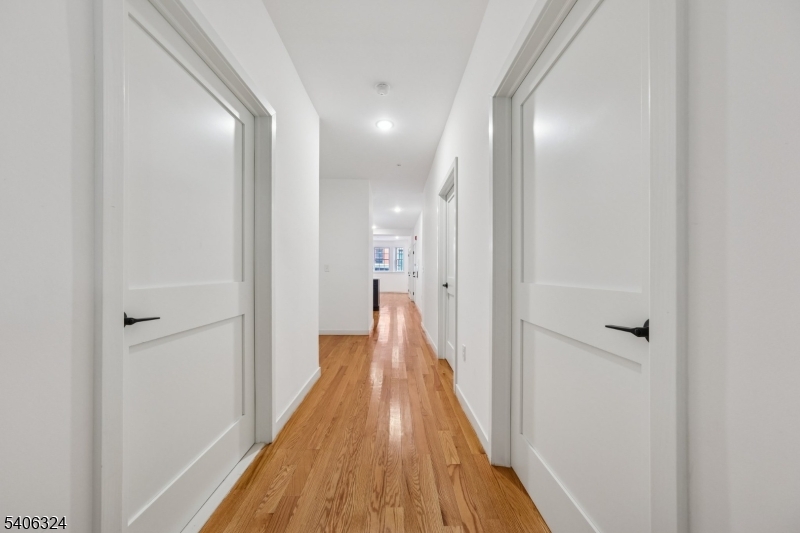 52 James Street, Unit 1 Newark, NJ 07102 - Photo 17 of 28 a view of a hallway with wooden floor
