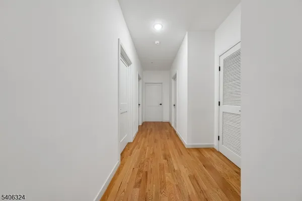 a view of a bedroom with wooden floor