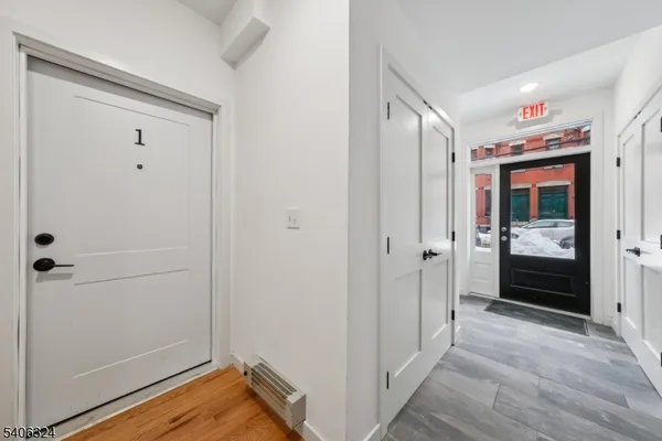 a view of a hallway with wooden floor