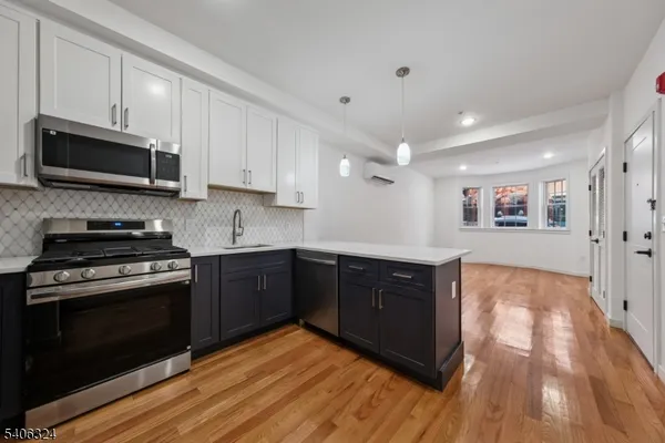 a kitchen with stainless steel appliances granite countertop wooden cabinets stove top oven and sink