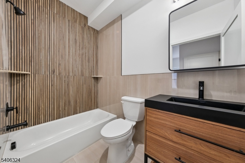 52 James Street, Unit 1 Newark, NJ 07102 - Photo 21 of 28 a bathroom with a sink a toilet and vanity