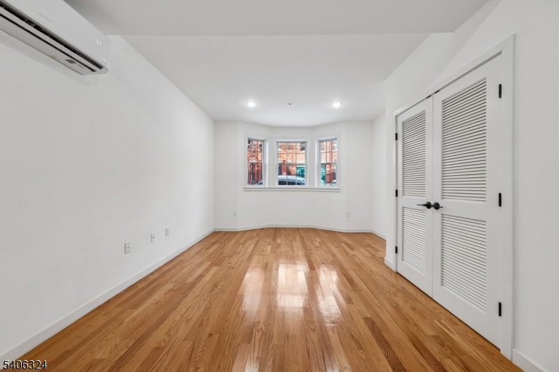 52 James Street, Unit 1 Newark, NJ 07102 - Photo 6 of 28 a view of hallway with wooden floor and a window