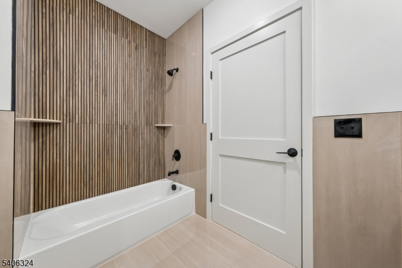 52 James Street, Unit 1 Newark, NJ 07102 - Photo 10 of 28 a bathroom with a bathtub and a shower