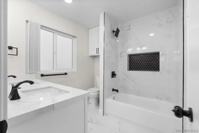 a bathroom with a bathtub and a sink