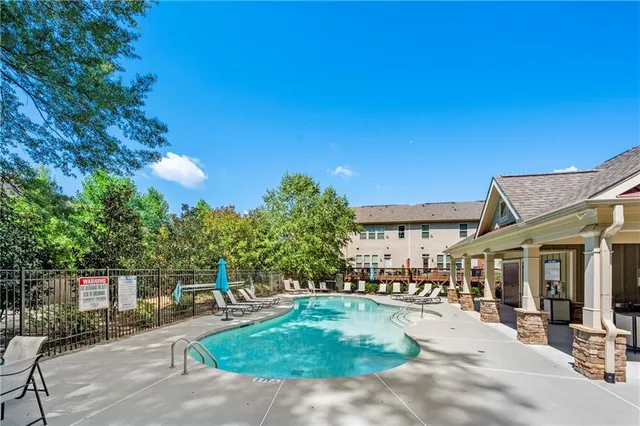 a swimming pool with outdoor seating and yard