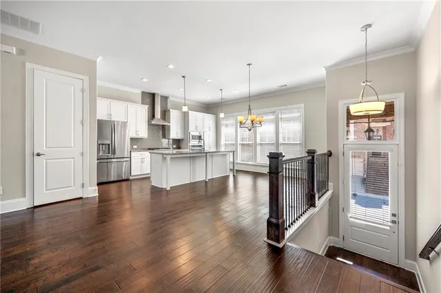 a view of kitchen with stainless steel appliances refrigerator oven and cabinets