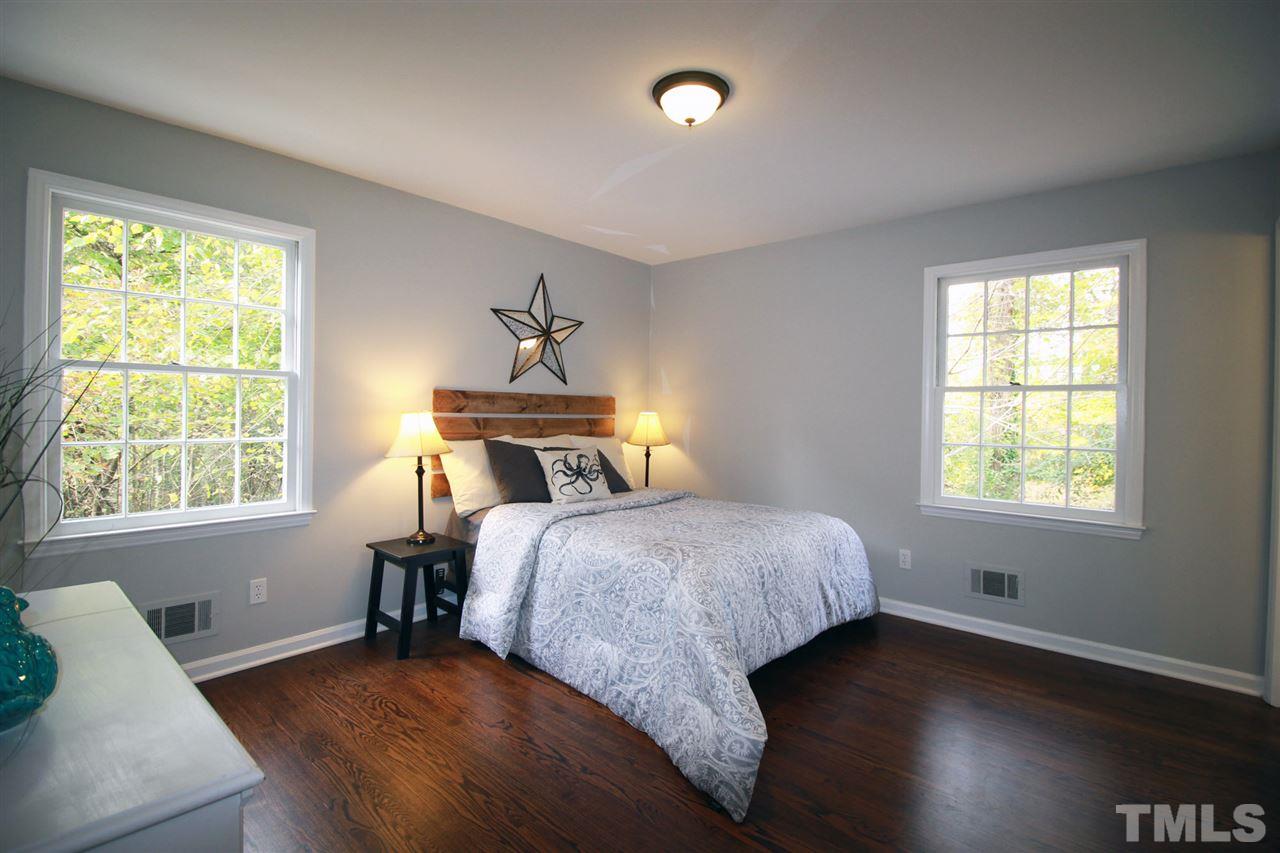 308 Lord Berkley Road Raleigh, NC 27610 - Photo 14 of 25 a bedroom with a bed and wooden floor