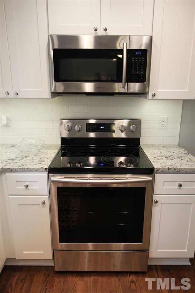 308 Lord Berkley Road Raleigh, NC 27610 - Photo 8 of 25 a stove top oven sitting inside of a kitchen