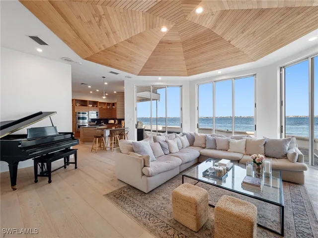 a living room with furniture and a piano