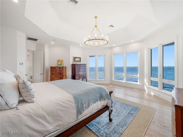 a spacious bedroom with a large bed and a window