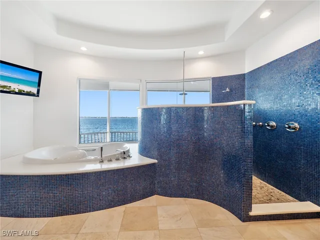 a bathroom with a tub sink and mirror