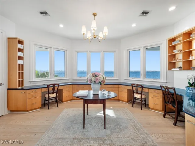 a view of a a dining room with furniture window and wooden floor
